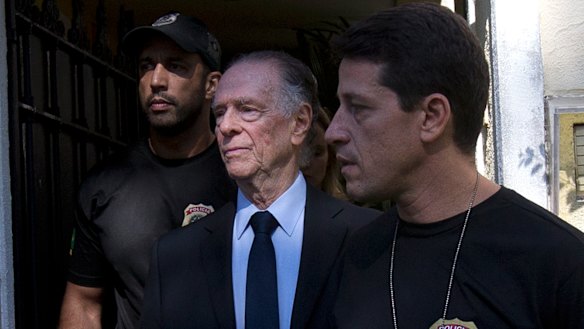 Carlos Nuzman, President of the Brazilian Olympic Committee, center, is escorted by federal police officers after being taken into custody at his home, in Rio de Janeiro, Brazil, in 2017.