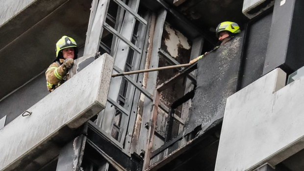 Firefighters inspect the damage at Melbourne’s Neo 200 building in 2019.