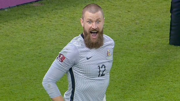 Australian goalkeeper Andrew Redmayne celebrates after making the crucial  save in the penalty shootout against Peru