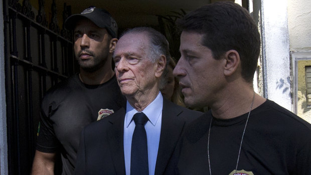 Carlos Nuzman, President of the Brazilian Olympic Committee, center, is escorted by federal police officers after being taken into custody at his home, in Rio de Janeiro, Brazil, in 2017.