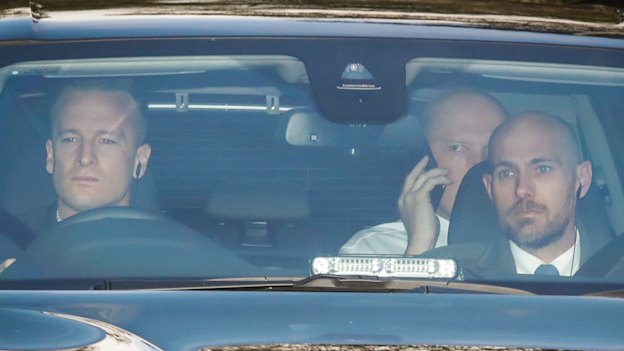 Peter Dutton working the phones as he arrives at Parliament House.