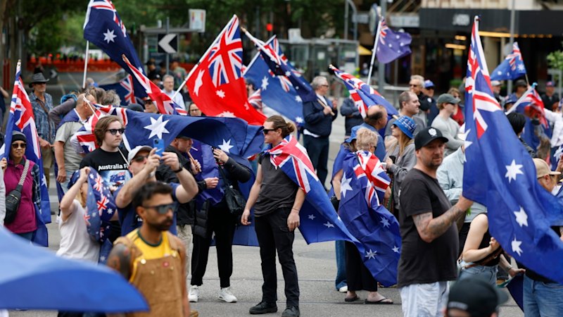 Two officers hospitalised, flags burnt and missiles thrown at police as opposing protesters converge in CBD