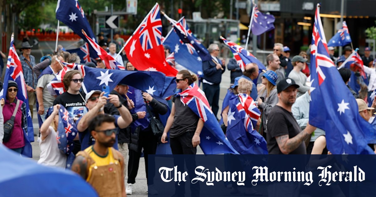Two officers hospitalised, flags burnt and missiles thrown at police as opposing protesters converge in CBD