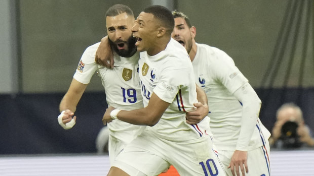 France’s Karim Benzema and Kylian Mbappe celebrate a goal.