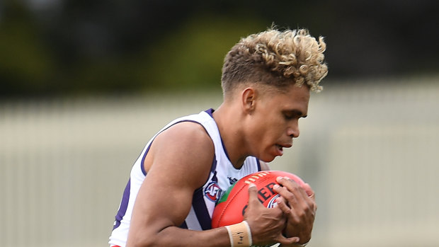 Liam Henry of the Dockers takes a mark.