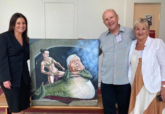 Senator Jacqui Lambie in her office with the Bald Archies portrait depicting her as Princess Leia and Clive Palmer as Jabba the Hutt, which was dropped off by owners Ray and Elain.