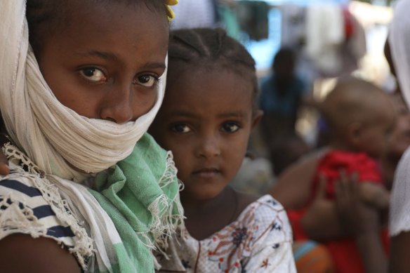 Refugees from the Tigray region of Ethiopia region wait to register at the UNCHR center at Hamdayet, Sudan.