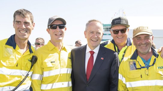 Opposition Leader Bill Shorten poses for photos with Toll workers following the official naming ceremony for Australia's newest and biggest cargo ship, Victorian Reliance II (VRII) in Port Melbourne, Sunday, February 24, 2019. (AAP Image/Ellen Smith) NO ARCHIVING