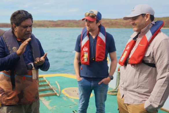 Yindjibarndi law man and deputy chairperson of the Murujuga Aboriginal Corporation Vince Adams speaks with geomorphologist Professor Mick O’Leary and submarine archaeologist Professor Jonathan Benjamin.