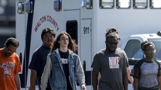 Students and parents walk off campus at Apalachee High School.