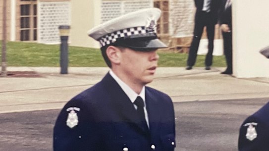 Tim Peck (left) graduates from the Police Academy.