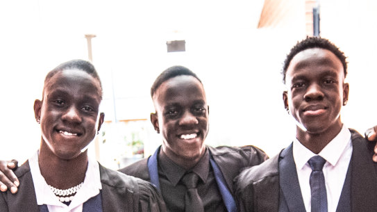 South Sudanese triplets Kon, Riak and Mom Daw arrive at their year 12 graduation ceremony at Catholic Regional College Sydenham.