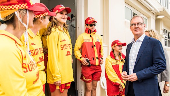 Labor leader Daley meets local surf life savers in Coogee while campaigning on Saturday.