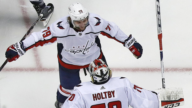 Nathan Walker (top) celebrates the Caps' win.