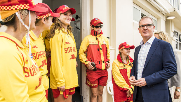 Labor leader Daley meets local surf life savers in Coogee while campaigning on Saturday.