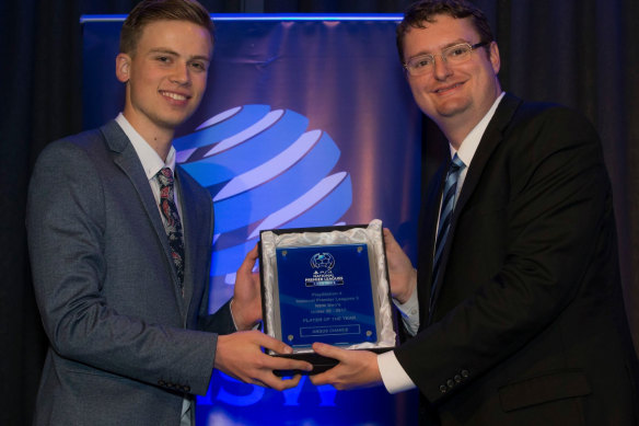 Angus Chance receives his award as the NSW NPL3's under-20s player of the year in 2017 from Stuart Hodge, the chief executive of Football NSW.