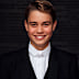 After Prince George arrived, he got into his school uniform, which is a formal suit with pinstripe trousers and coattails on the jacket, paired with a white tie.