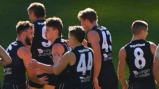 MELBOURNE, AUSTRALIA - MAY 22: Sam Walsh of the Blues is congratulated by team mates after kicking a goal during the round 10 AFL match between the Carlton Blues and the Hawthorn Hawks at Melbourne Cricket Ground on May 22, 2021 in Melbourne, Australia. (Photo by Quinn Rooney/Getty Images)