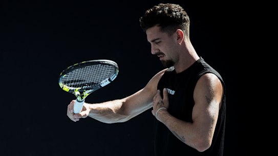 Thanasi Kokkinakis grimaces in pain and feels his injured pec during a practice session at last year’s Australian Open.
