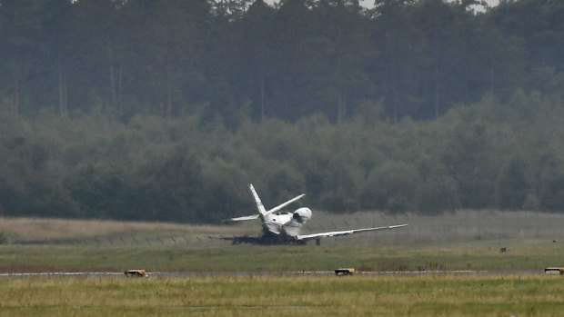 The private aircraft near the runway after it caught fire on landing at Aarhus Airport in Tirstrup, Denmark.