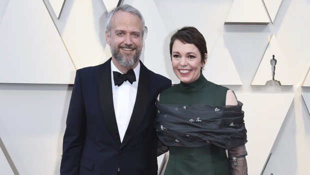 Olivia Colman and her husband Ed Sinclair arrive at the Oscars. 
