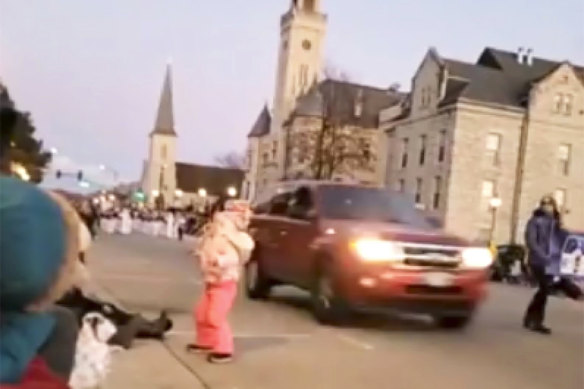 The SUV was captured on video speeding past a young girl and others attending a Christmas parade and continues to drive through the parade.