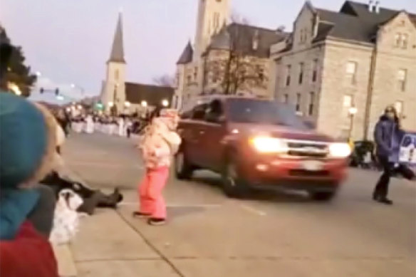 The SUV was captured on video speeding past a young girl and others attending the Christmas parade.