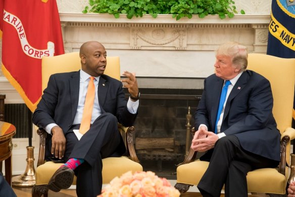 Donald Trump, US president at the time, speaks to Senator Tim Scott during a meeting at the White House in 2017.