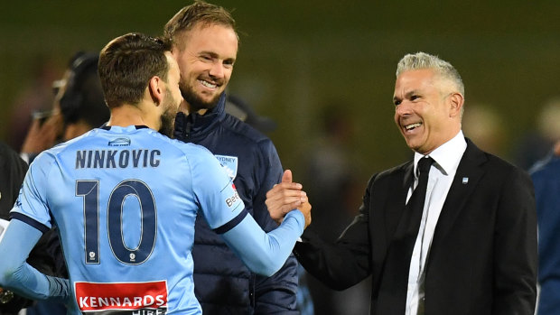 Sydney FC coach Steve Corica (right)  congratulates Milos Ninkovic after their incredible win on Sunday night. 
