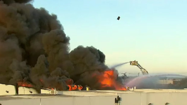 A chemical drum can be seen flying through the air above the inferno on Friday. 
