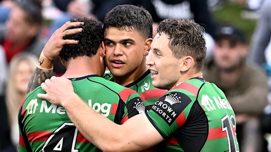 Latrell Mitchell celebrates scoring a try with Rabbitohs teammates.