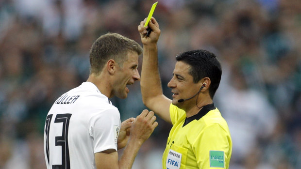 Headed for the A-League: Referee Alireza Faghani shows a yellow card to Germany's Thomas Mueller during a group match at the 2018 World Cup.