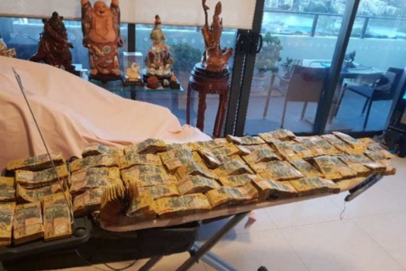 Philip Uy gave evidence he took this photograph of cash piled on an ironing board inside his Rhodes apartment in July 2018. He estimated it amounted to about $300,000, a corruption inquiry heard.