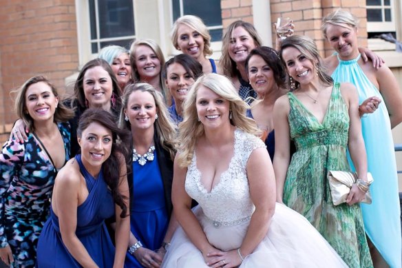 Katie McIver (centre) at her wedding with friends from high school.