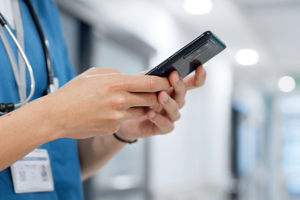 Hands, phone and healthcare with a nurse scrolling in a hospital closeup for research or networking. Medical, communication and information with a medicine professional reading a text in a clinic