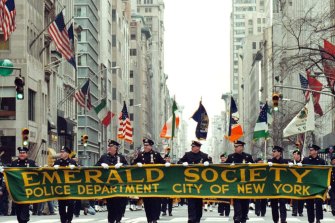 New York City Police Department’s Emerald Society marches through the city on St Patrick’s Day.