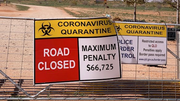 Signs warn of penalties for entering Qld from NSW at one of the many border crossings set up to keep out  COVID-19.