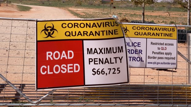 Signs warn of penalties for entering Qld from NSW at one of the many border crossings set up to keep out  COVID-19.