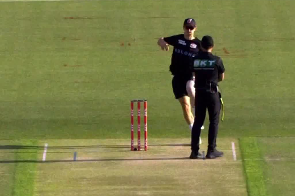 Sydney Sixers bowler Tom Curran runs at an umpire before a BBL match.