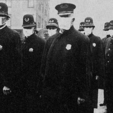Seattle police wear protective masks during the 1918 flu pandemic, which killed tens of millions.
