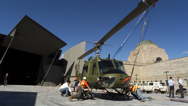 A picture from 2001 showing an Iroquois helicopter from the Royal Australian Air Force that flew in Vietnam in 1966 being transported by truck to the then-new Anzac Hall at the rear of the Memorial.
