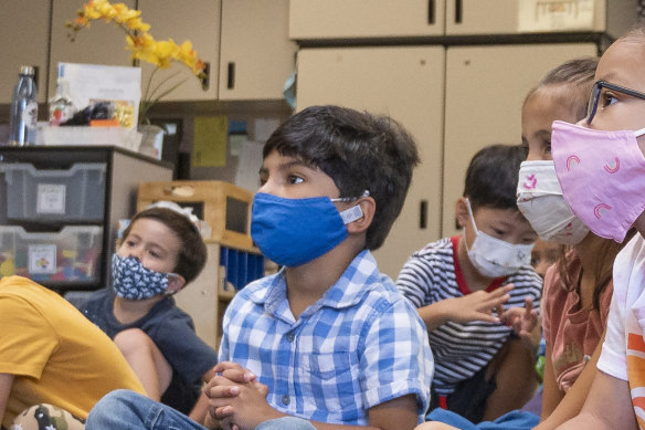 Children listen to their teacher during their first day of transitional kindergarten at Tustin Ranch Elementary School in California.