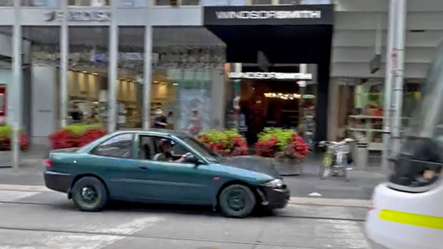 The car is seen speeding through the Bourke Street Mall.