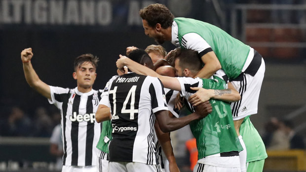 Late drama: Juventus players celebrate their comeback win.