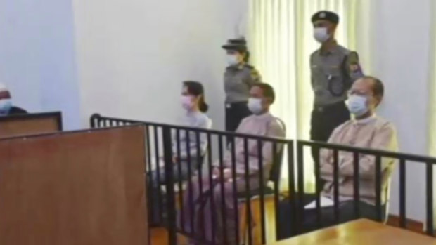 An image of Aung San Suu Kyi, left, in court in Naypyitaw in May which was shown on military-run television.