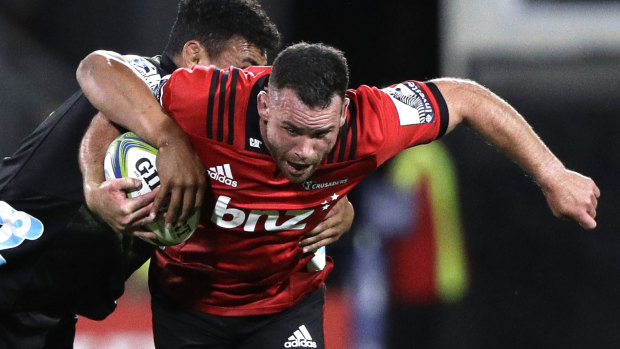 Crusaders star Ryan Crotty busts through the Hurricanes defence. 