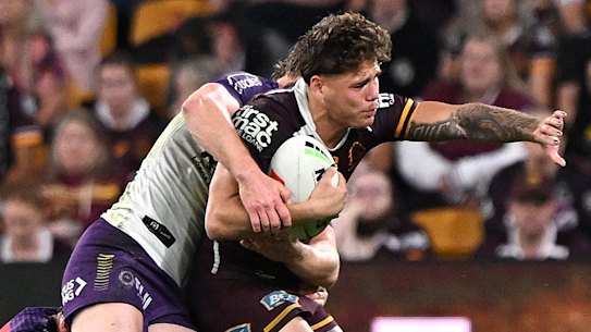 Reece Walsh is wrapped up by the Storm.