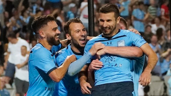 Leaving it late: Kosta Barbarouses (right) fired home to seal a win for Sydney FC against Melbourne City.