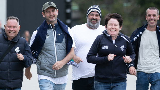 Carlton fans from left David Gould, Nic Wishart, Benji Innella, Heather Cotton and Jason Parish rejoice at being able to watch men’s AFL at a stadium again.