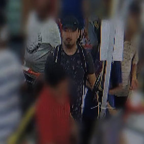 The second man is depicted in the images as wearing a black shirt with a pattern, a white backpack and a black cap.